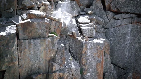 Large stones fall from the mountain and break against the rocks 2 動画素材 103967596