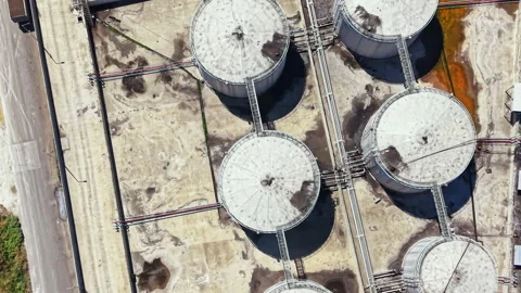 Large storage tanks at an industrial facility near a highway with clear paths Video stock 341074305