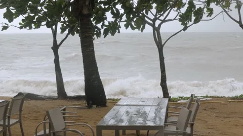 Large storm waves crash onto beach as strong winds blow spray into the air wi Stock Footage 220000025