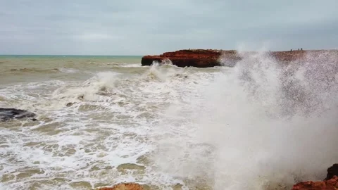 Large storm waves crashing against rocky coastline during daytime Stock Footage 342022732