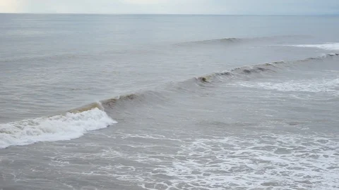 Large storm waves crashing one by one on the long coast of a tropical island Stock Footage 88260867