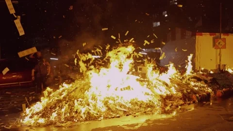 Large Street Bonfire with Flying Joss Paper Confetti during Hungry Ghost Stock Footage 345994448