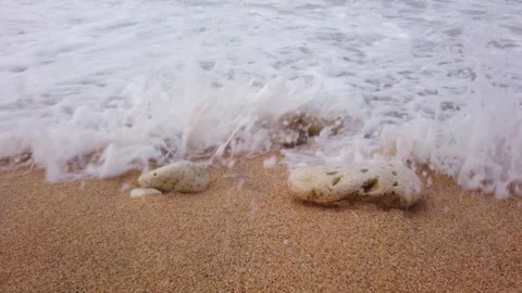 Large strong waves with white foam. Sandy beach with large stones. Windy, cloudy Stock Footage 138531497