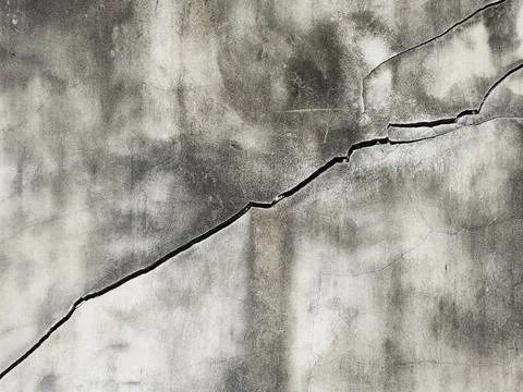 Large structural diagonal cracks and many cracks right top corner on cement Stock Photos