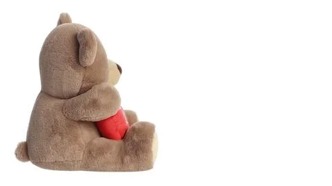 Large stuffed bear holding a red heart isolated on white background Fotos de archivo