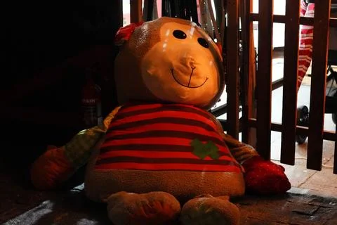Large stuffed monkey toy sitting on floor Stock Photos