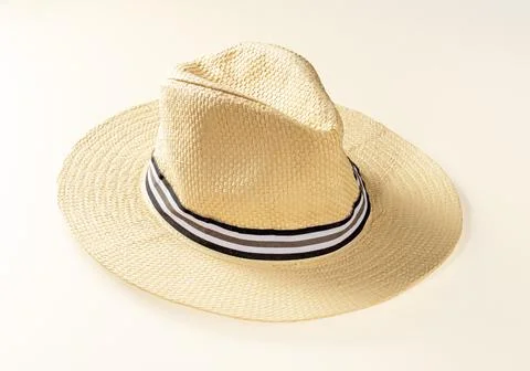 Large sun hat made of light straw for holidays on a light background Stock Photos