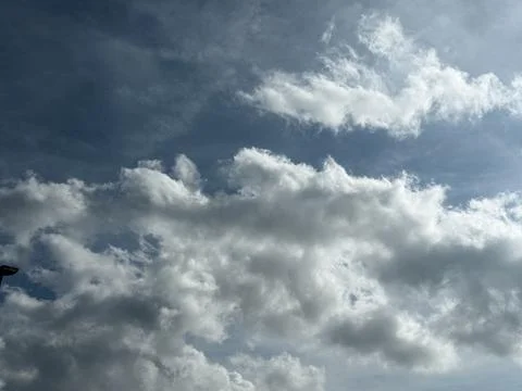 Large Sunlit Clouds Across Blue Gray Sky Stock Photos