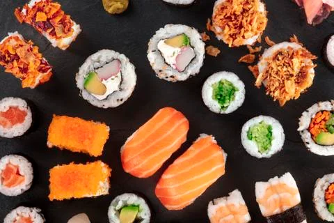 Large sushi set, close-up overhead shot on a black background. An assortment of Stock Photos