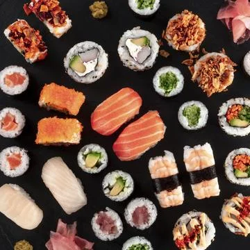 Large sushi set, overhead square close-up shot on a black background. An Stock Photos