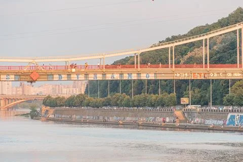 Large suspension bridge over a river in Kyiv, Ukraine Bridge has multiple c.. Stock Photos