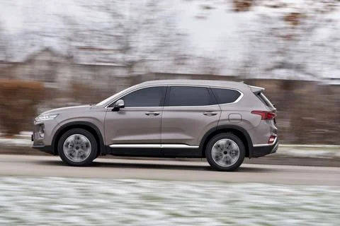 A large SUV is moving at high speed Stock Photos