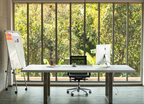 A large table with a computer of CEO and nature background Foto stock