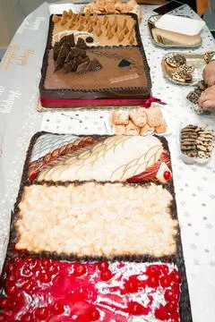 A large table filled with assorted birthday cakes Stock Photos