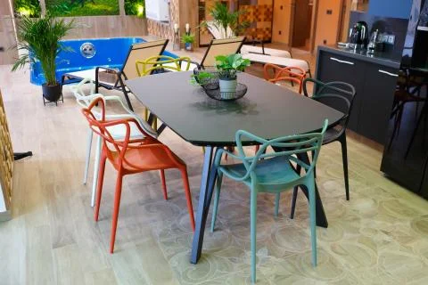 A large table in the middle of the kitchen with six chairs. Stock Photos