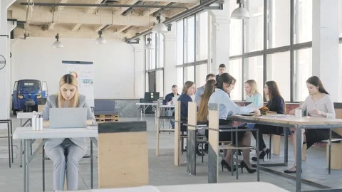 At a large table sits a team of developers and holds a meeting. A young manager Stock Footage 109420067