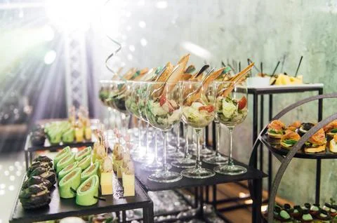 Large table with snacks of different types at a party with creative disco Stock Photos