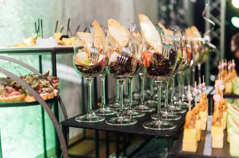 Large table with snacks of different types at a party with creative disco Stock Photos