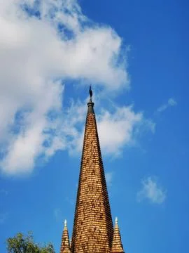 A large tall tower with a clock on the side of a building Stock Photos