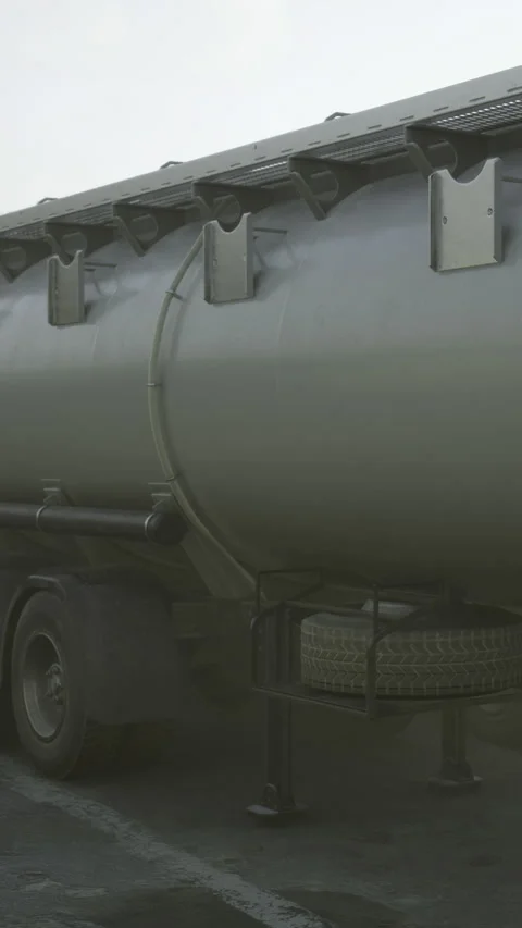 Large tank truck parked at a loading area near a warehouse facility Stock Footage 334726126