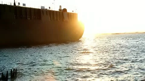 Large tanker pulls out into New York harbor at sunset Stock Footage 12113255