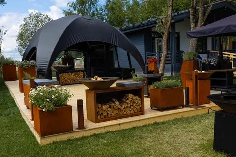 A large tent with a black dome for relaxing and barbecue. Backyard arrangemen Stock Photos