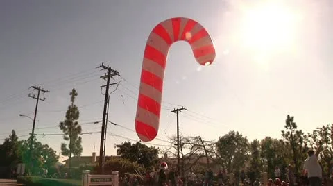 Large tethered inflatable floating Candy Cane Christmas parade stock footage Stock Footage 10699752