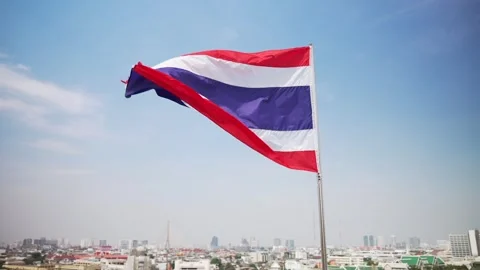 Large Thai flag against densely built-up area of city Video stock 303684599