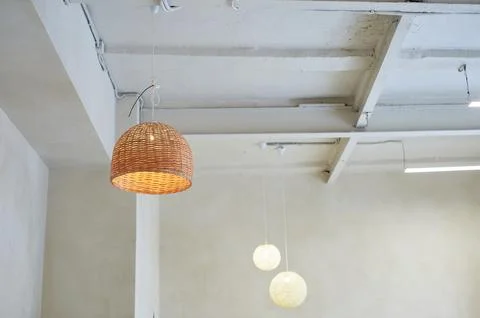 Large thatched ceiling lamp. Loft style. High ceilings with rails. Minimalism. Stock Photos