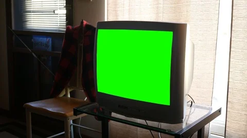 A large thick standard definition green screen generic Television in living room Stock Footage 88065782