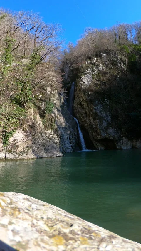 A large thirty-meter waterfall creates a deep lake. Stock Footage 147321238