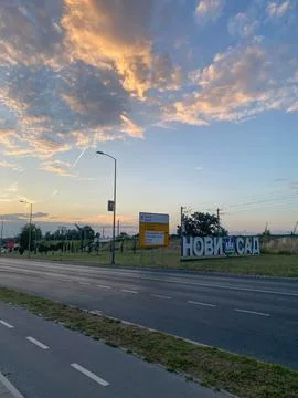 Large three-dimensional Cyrillic sign spelling Novi Sad stands beside a road Stock Photos