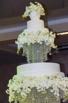Large three-tiered cake on separate trays. The wedding cake is highlighted in Stock Photos