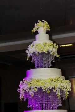 Large three-tiered cake on separate trays. The wedding cake is highlighted in Stock Photos