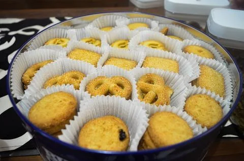 A large tin containing various kinds of biscuits to serve guests for Eid al.. Stock Photos