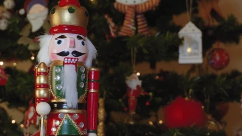 Large tin nutcracker soldier on a Christmas tree with blurred background. Stock Footage 99369439