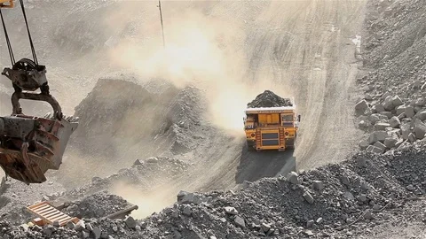 A large tipper digs through a career, an industrial truck dredges cargo in its Видео 77468748