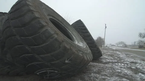 Large Tires pan to wind blown snow on street Stock Footage 40319414