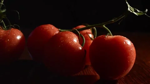 Large tomatoes on a black background Video stock 89139477