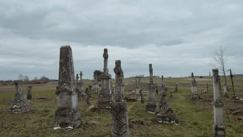 Large tombstone crosses on old graves against a blue sky background Stock Footage 253223622