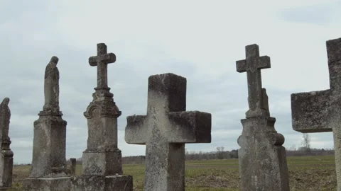Large tombstone crosses on old graves against a blue sky background Stock Footage 253223626