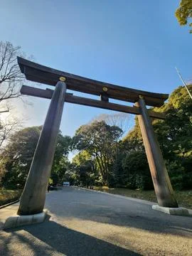 A large torii gate is shown in a park Stock Photos
