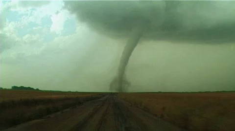 Large tornado directly ahead of a storm chasers car Stock Footage