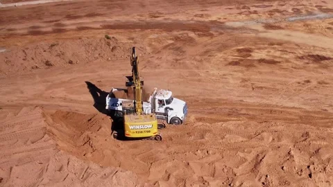 Large tracked excavator loading a tip truck Stock Footage 338064271