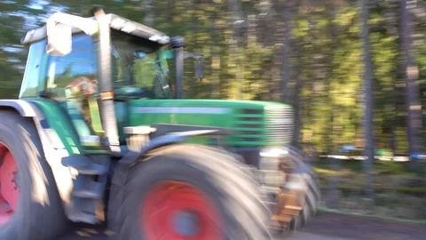 Large tractor carries rubble along an asphalt forest road. Stock Footage 112216861