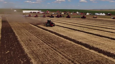 A large tractor plows a field before sowing Видео 123045913