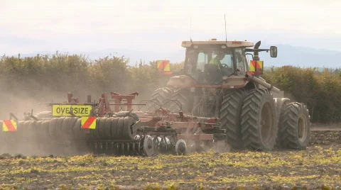Large tractor pulling large cultivation implement Stock Footage 871264