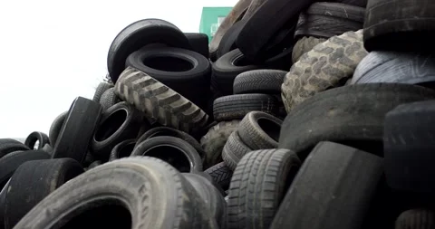 Large Tractor Tire In A Used Rubber Heap, Off Road Casing Pile, Low Angle Shot Stock Footage 340664782