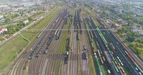 Large Train depot top view. Many freight color trains in the railway depot Видео 143077995