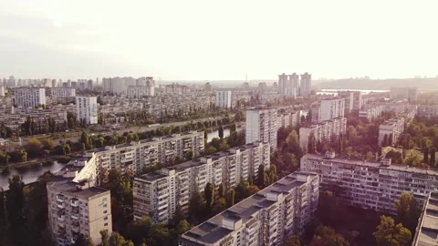 Large tranquil residential area with trees around and a flowing river at sunset Stock Footage 141419213